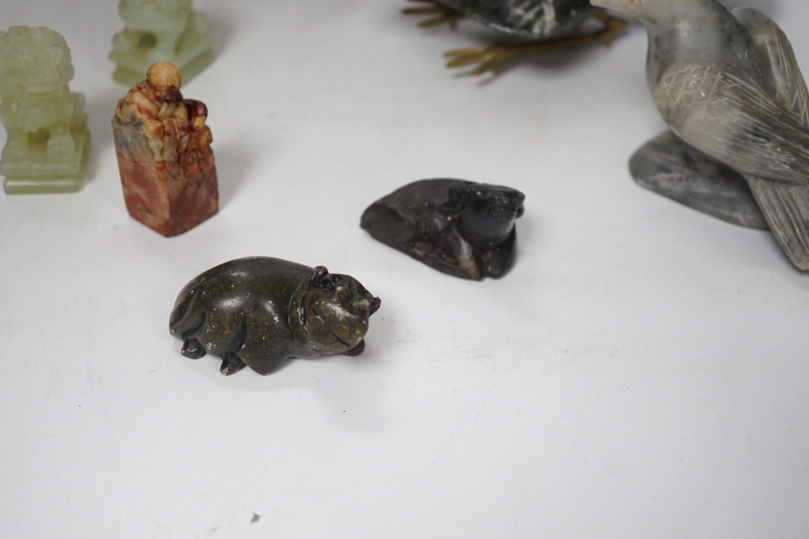 A group of Chinese soapstone and bowenite animal figures and a figural seal, largest 25cm wide (8)